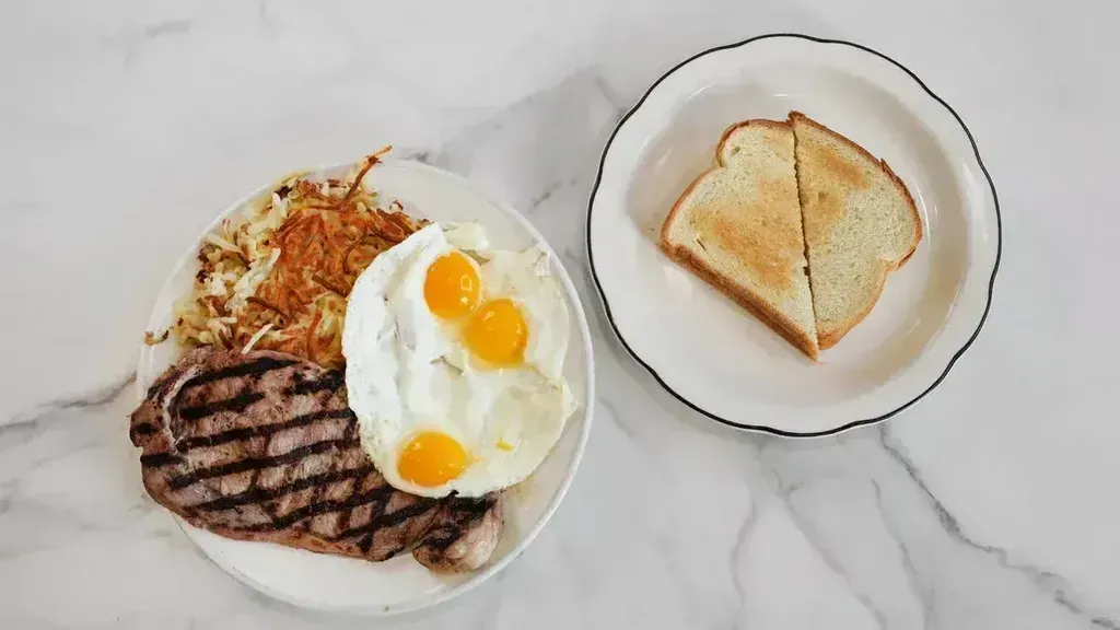 A grilled steak with fried eggs, hash browns, and toast at Harry's Cafe, Katella Ave, Stanton, CA