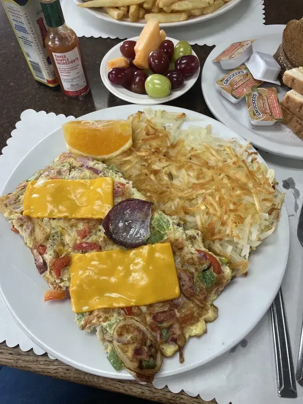 A loaded cheese omelette with hash browns and fresh fruit at Harry's Cafe, Katella Ave, Stanton, CA