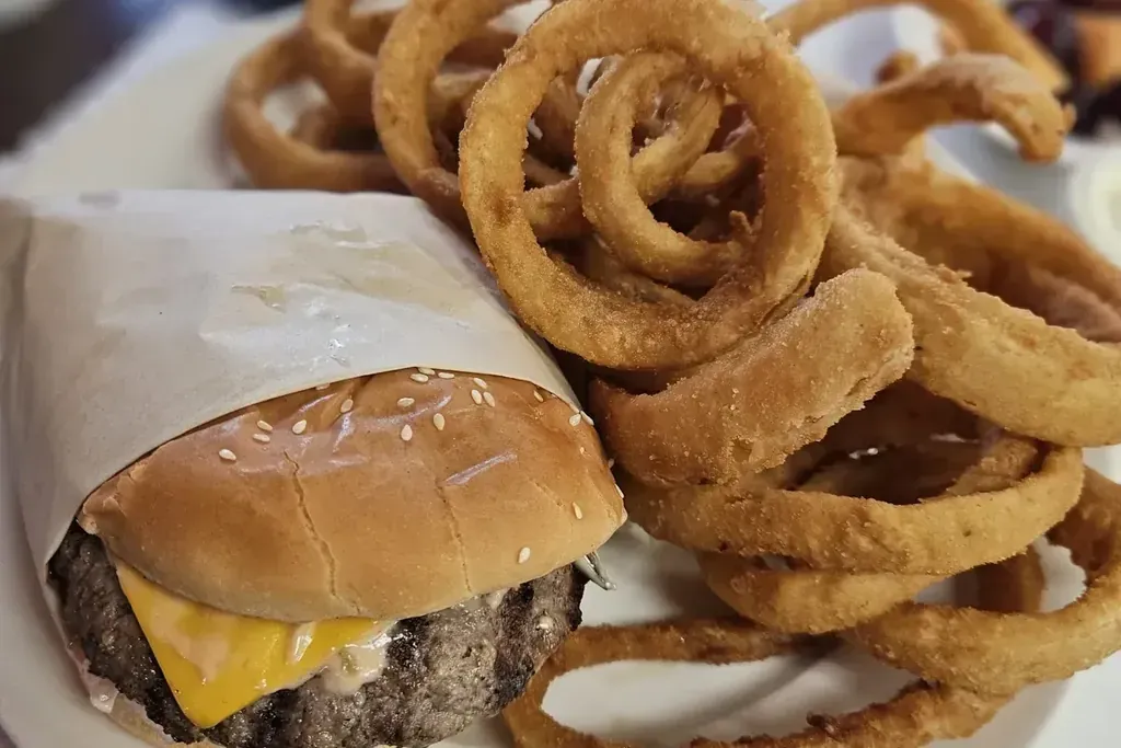 A cheeseburger with onion rings at Harry’s Cafe, Katella Ave, Stanton, CA.