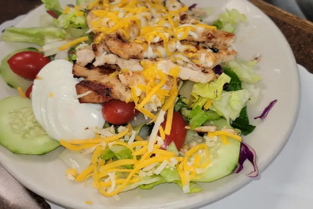 A grilled chicken salad with cheese and tomato at Harry's Cafe, Katella Ave, Stanton, CA