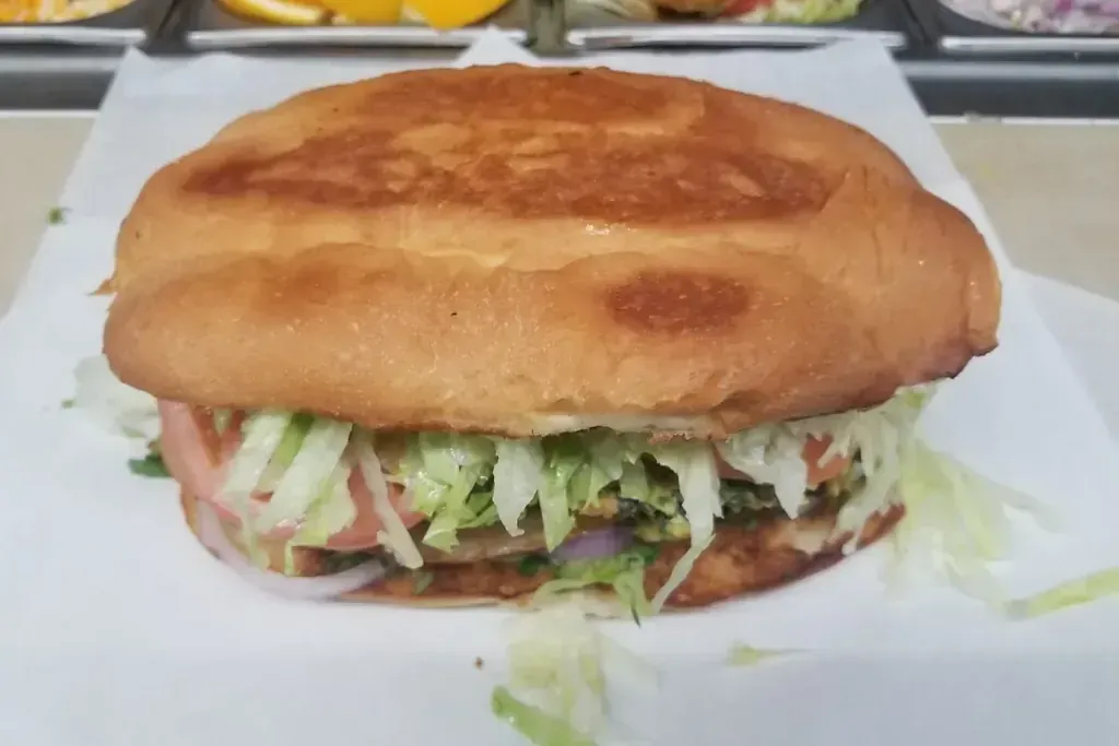A chicken sandwich on a toasted roll with lettuce and tomato at Harry’s Cafe, Katella Ave, Stanton, CA.