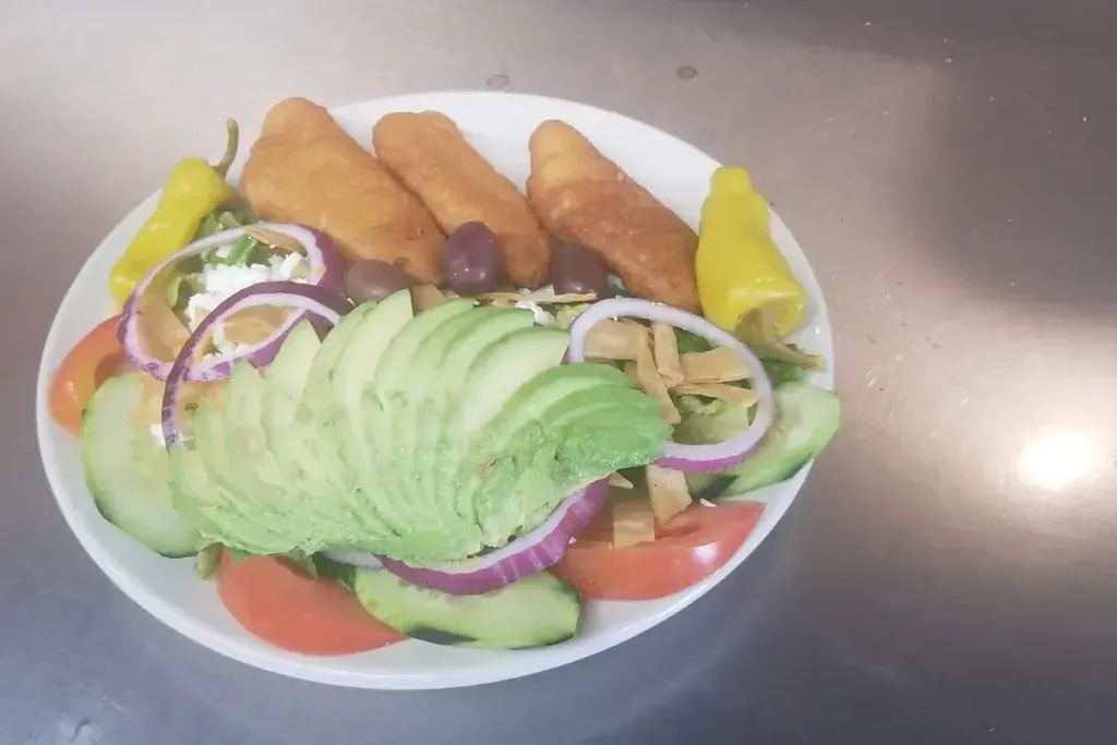 A green salad with avocado and tomato at Harry's Cafe, Katella Ave, Stanton, CA