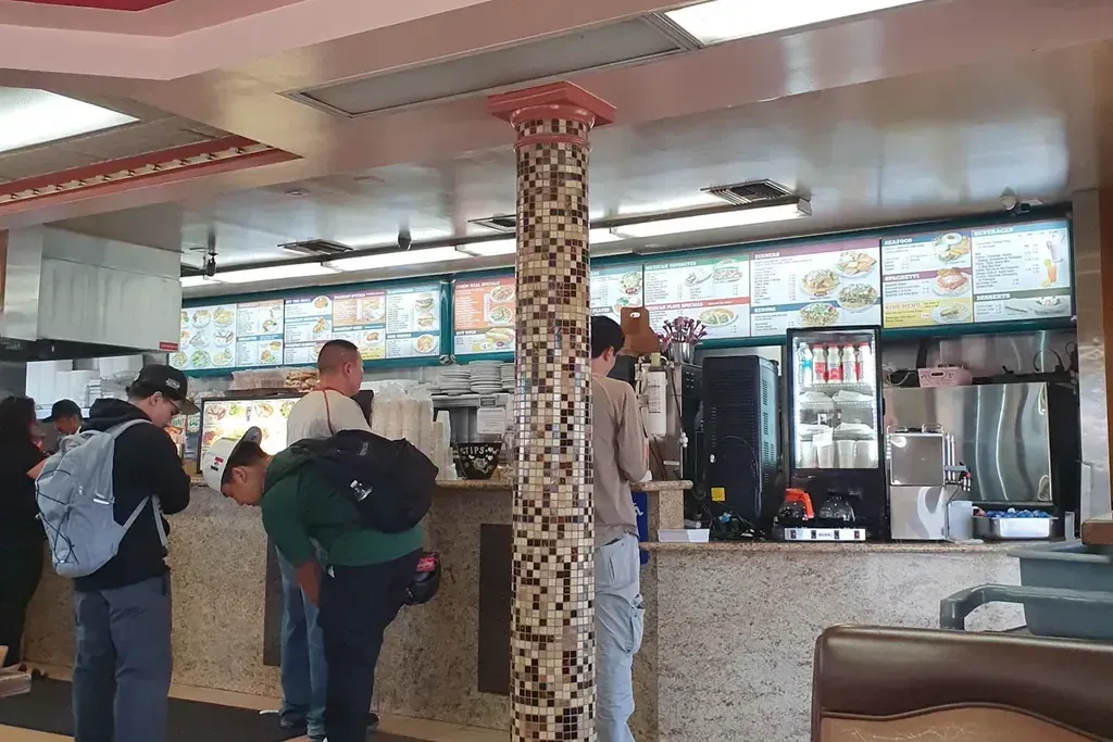 Guests lined up at the counter to order at Harry's Cafe, Katella Ave, Stanton, CA