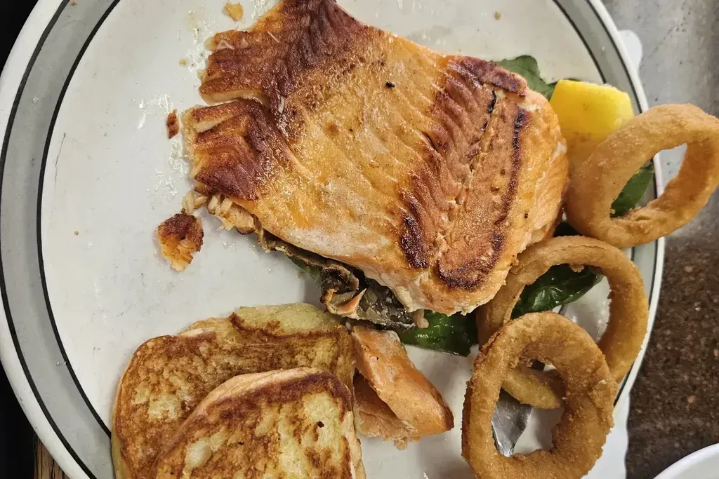 A grilled salmon plate with toast and onion rings at Harry’s Cafe, Katella Ave, Stanton, CA.