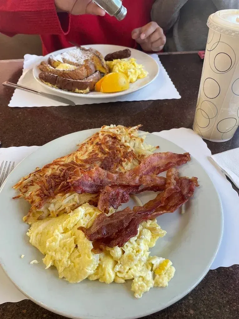 Hash browns, bacon and scrambled eggs on a plate at Harry's Cafe, Katella Ave, Stanton, CA