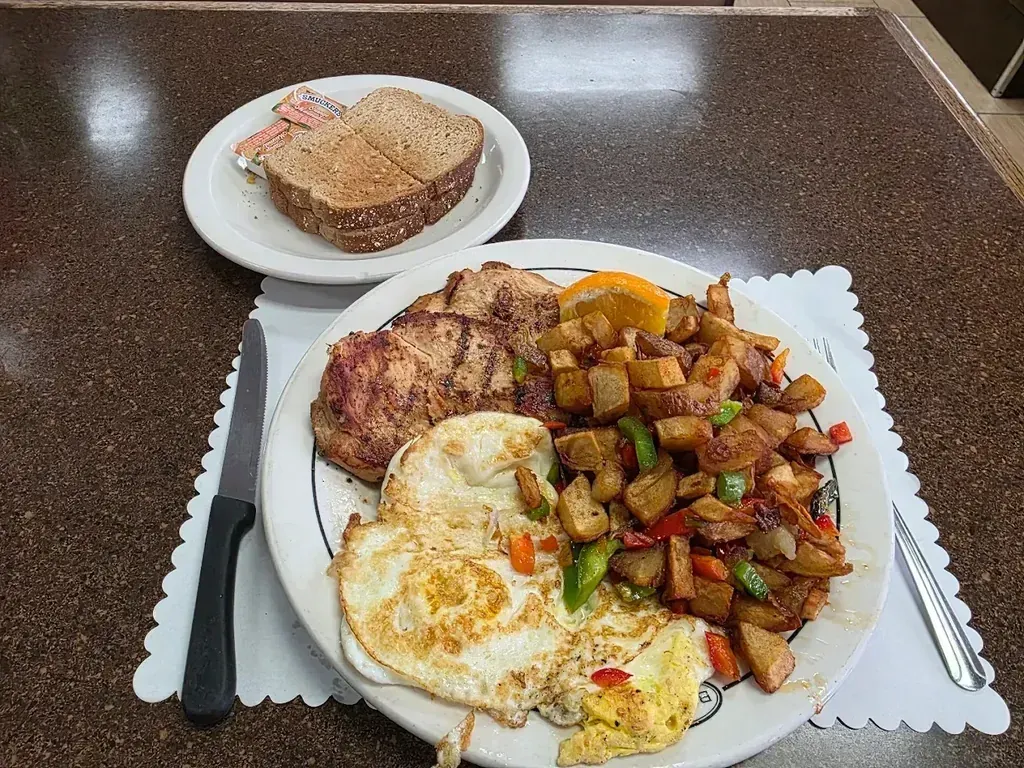 A pork chop with fried eggs, home fries and toast at Harry's Cafe, Katella Ave, Stanton, CA