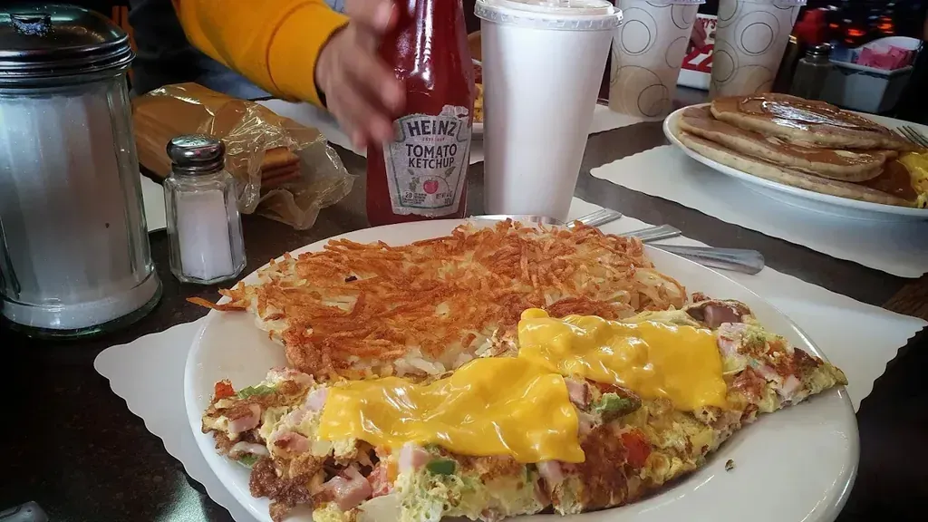 A ham and cheese omelette with hash browns and a stack of pancakes at Harry's Cafe, Katella Ave, Stanton, CA