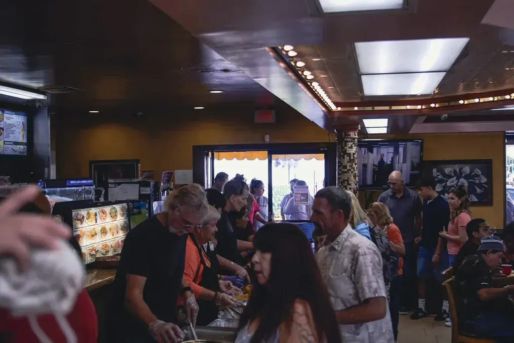 Staff and guests at the counter on a crowded morning at Harry's Cafe, Katella Ave, Stanton, CA