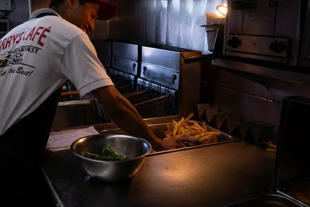 A cook working the fryer in the kitchen at Harry's Cafe, Katella Ave, Stanton, CA