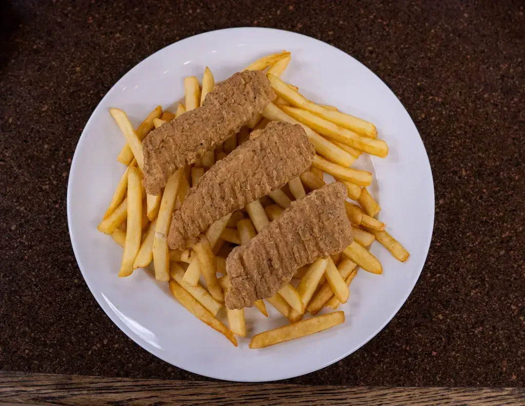 Three chicken strips on a pile of french fries at Harry's Cafe, Katella Ave, Stanton, CA
