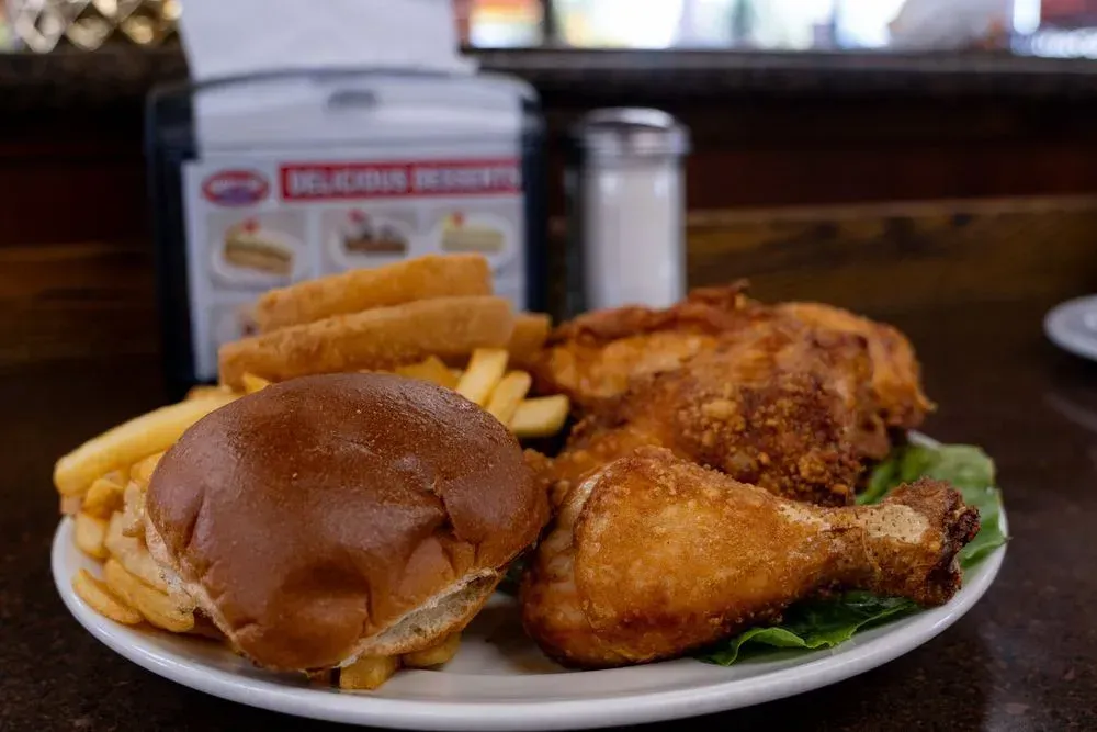 Broasted fried chicken with a bun and french fries at Harry's Cafe, Katella Ave, Stanton, CA