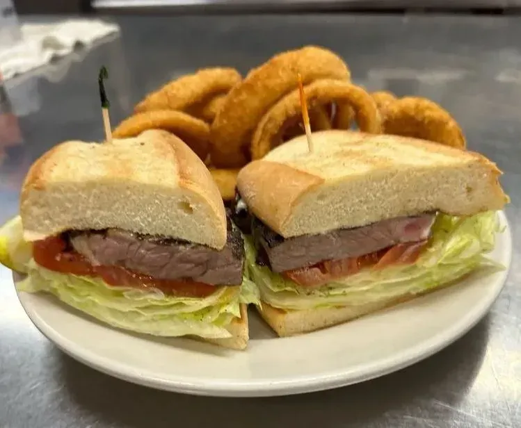 A steak sandwich on a roll with onion rings at Harry's Cafe, Katella Ave, Stanton, CA