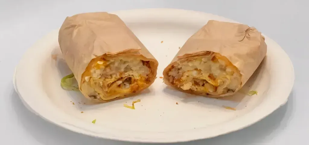 An egg and hash brown breakfast burrito cut in half at Harry's Cafe, Katella Ave, Stanton, CA