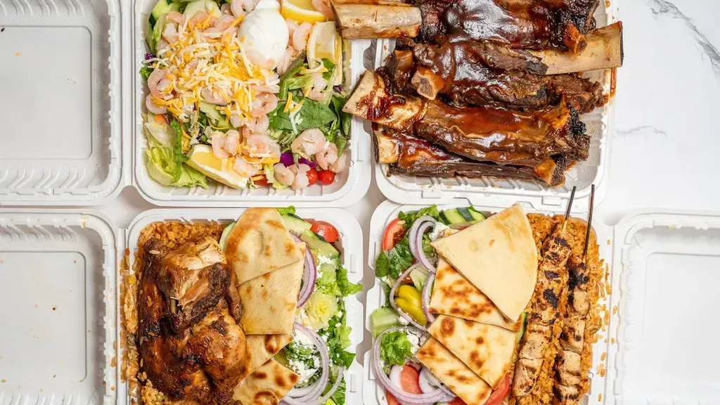 Four takeout boxes of shrimp salad, BBQ ribs, a chicken plate and a kebob plate at Harry's Cafe, Katella Ave, Stanton, CA