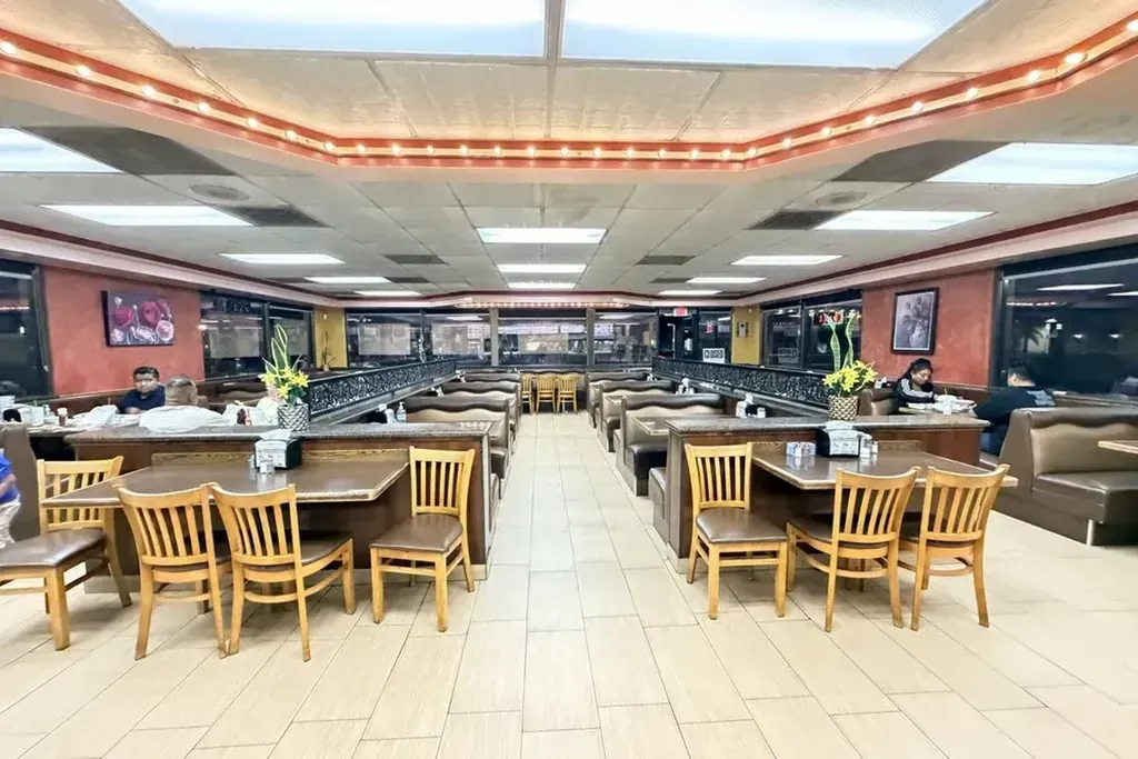 The dining room with rows of tables and booths at Harry's Cafe, Katella Ave, Stanton, CA