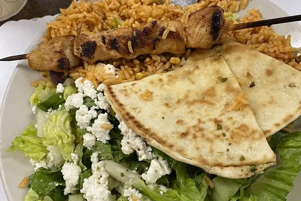 A chicken kebob plate with Greek salad, feta, and pita at Harry's Cafe, Katella Ave, Stanton, CA